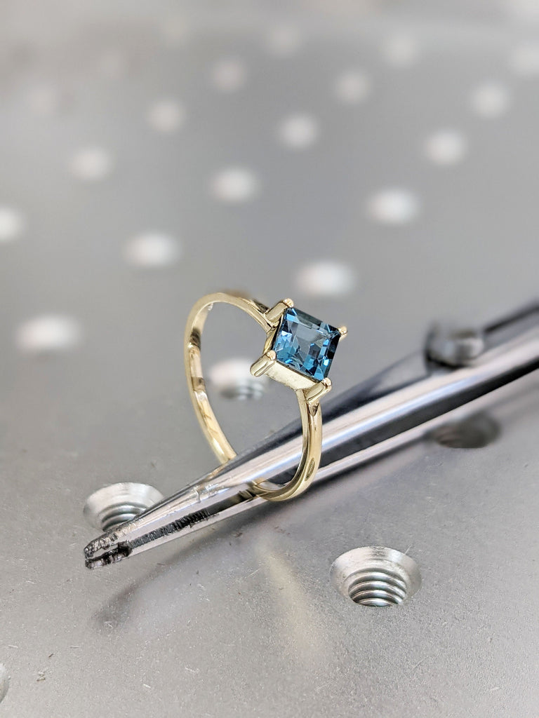 14k yellow gold Aria thin princess cut blue topaz ring offset prongs, delicate band, unique setting