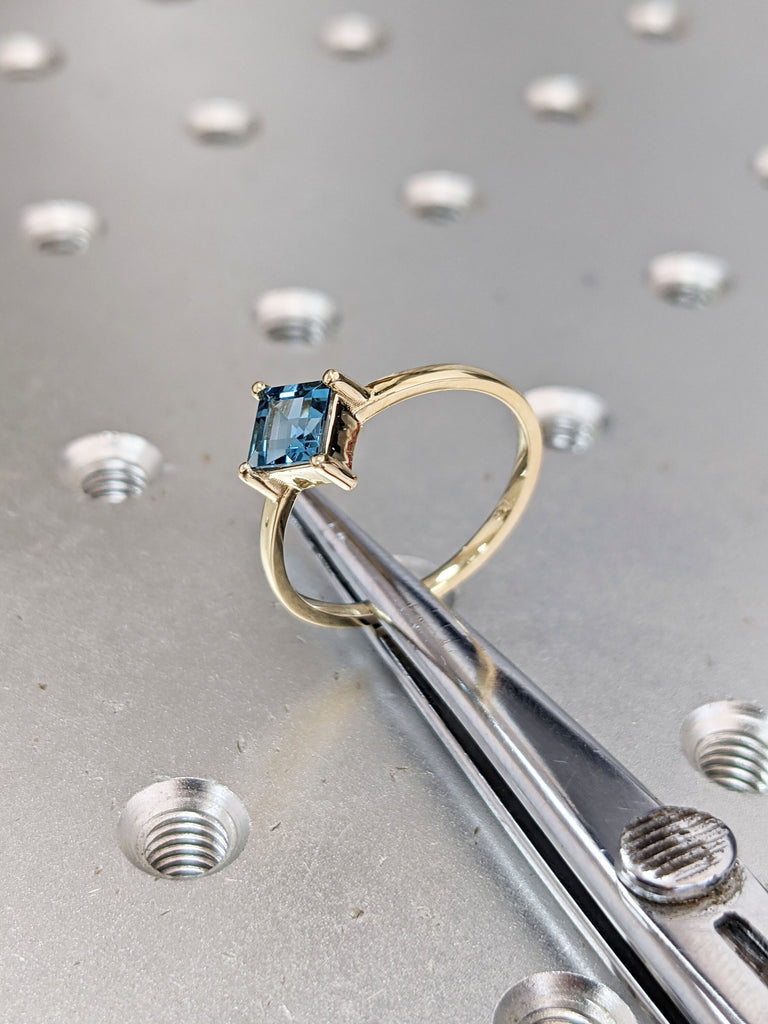 14k yellow gold Aria thin princess cut blue topaz ring offset prongs, delicate band, unique setting