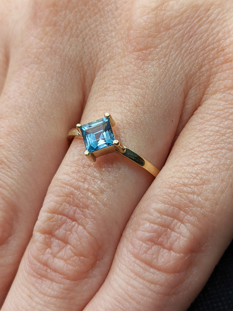 14k yellow gold Aria thin princess cut blue topaz ring offset prongs, delicate band, unique setting