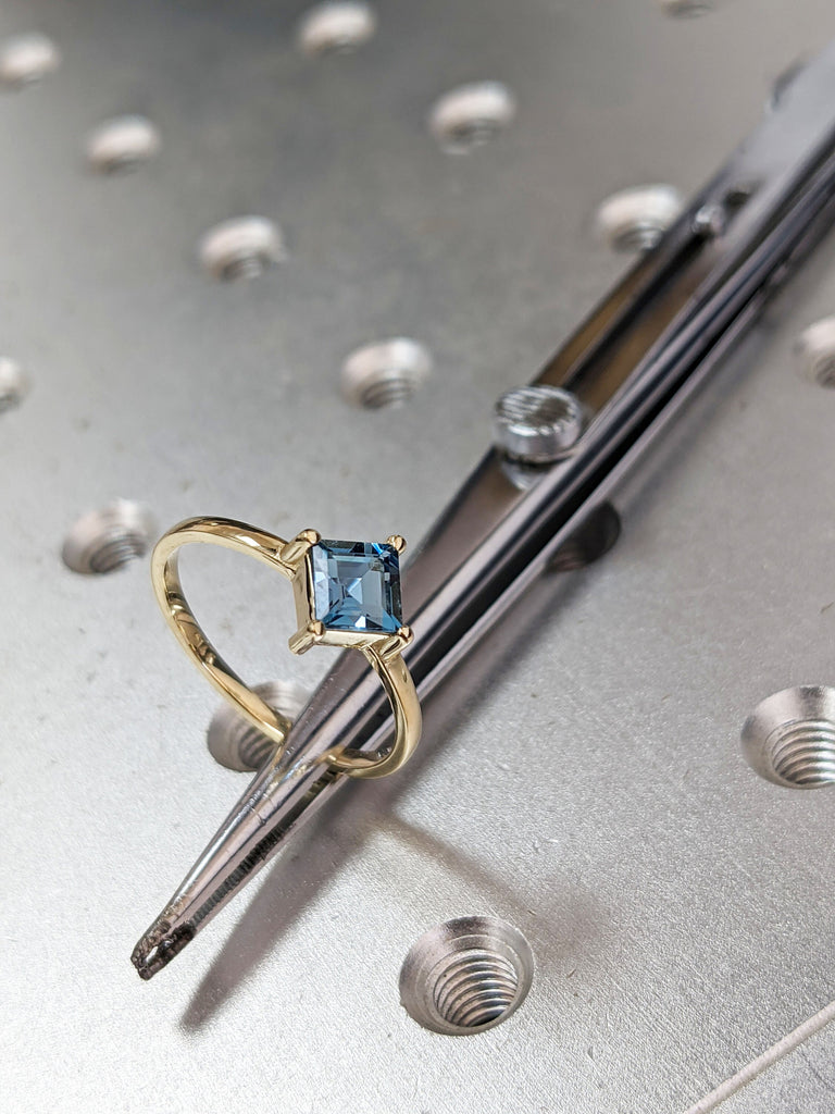 14k yellow gold Aria thin princess cut blue topaz ring offset prongs, delicate band, unique setting