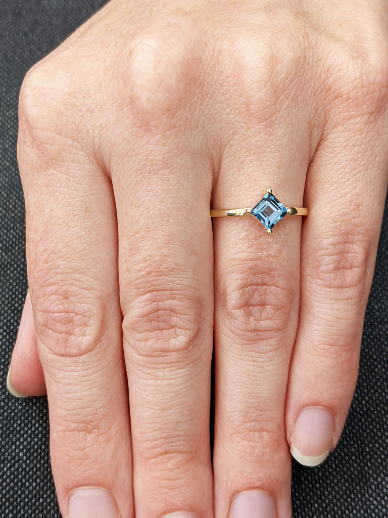 14k yellow gold Aria thin princess cut blue topaz ring offset prongs, delicate band, unique setting