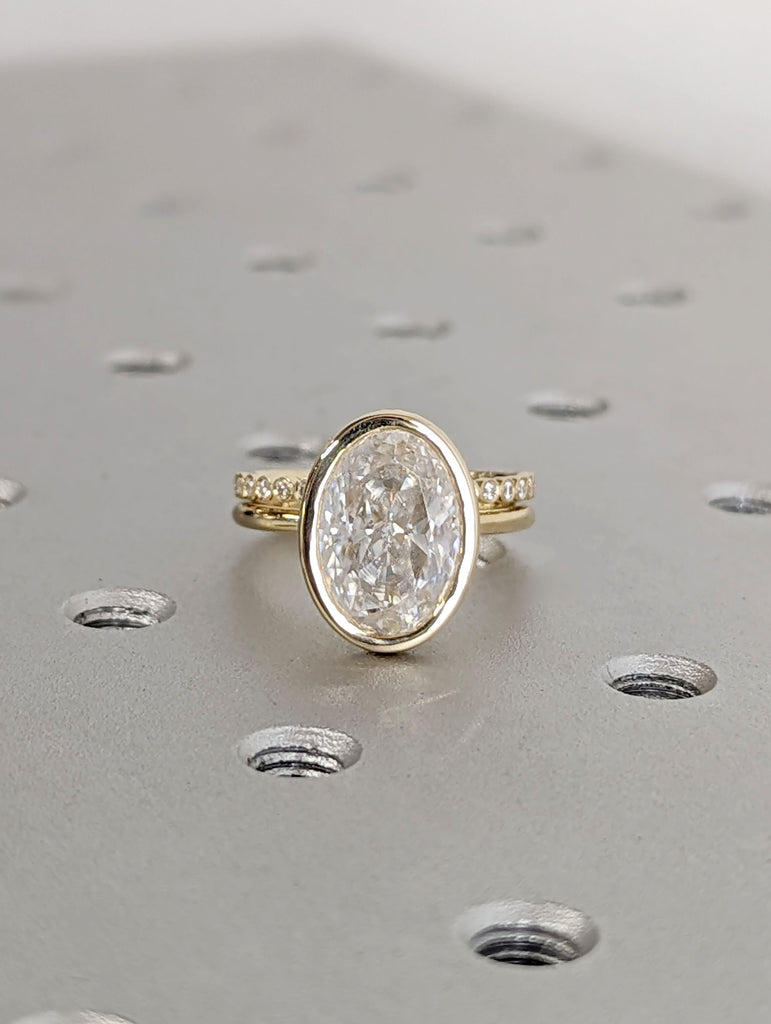 Yellow Gold Oval Moissanite Engagement Ring with Matching Moissanite Half Eternity Wedding Band