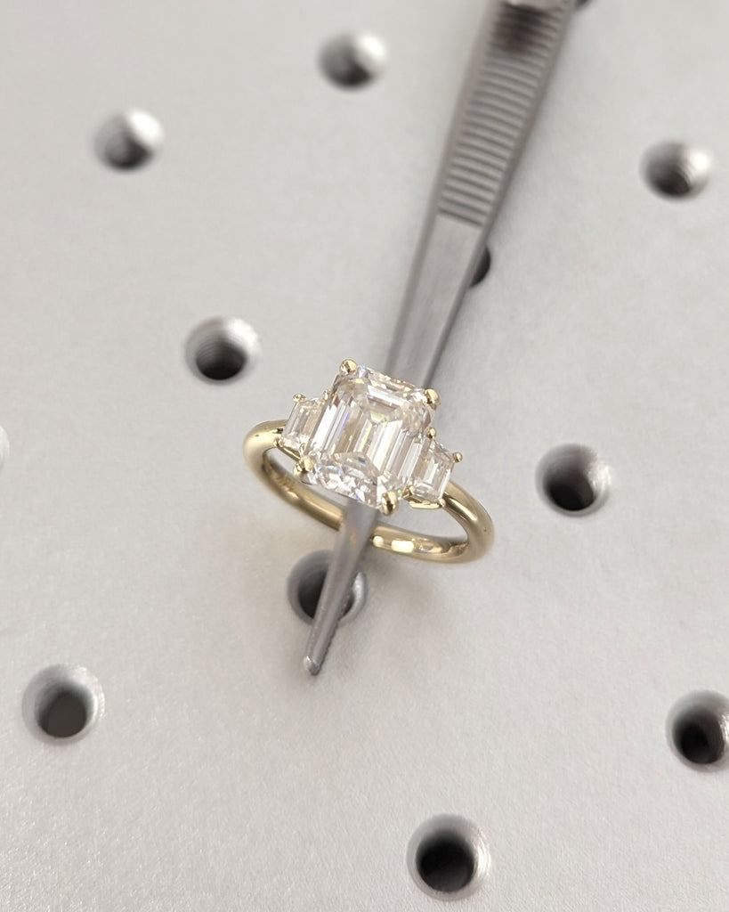 Emerald Cut Moissanite Engagement Ring. Three Stone Design with Trapezoid Accents. Unique Trellis Setting for Elegant Three Stone Ring Women