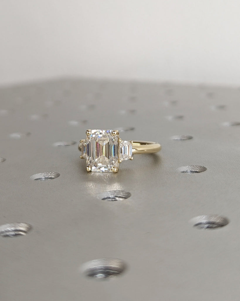 Emerald Cut Moissanite Engagement Ring. Three Stone Design with Trapezoid Accents. Unique Trellis Setting for Elegant Three Stone Ring Women