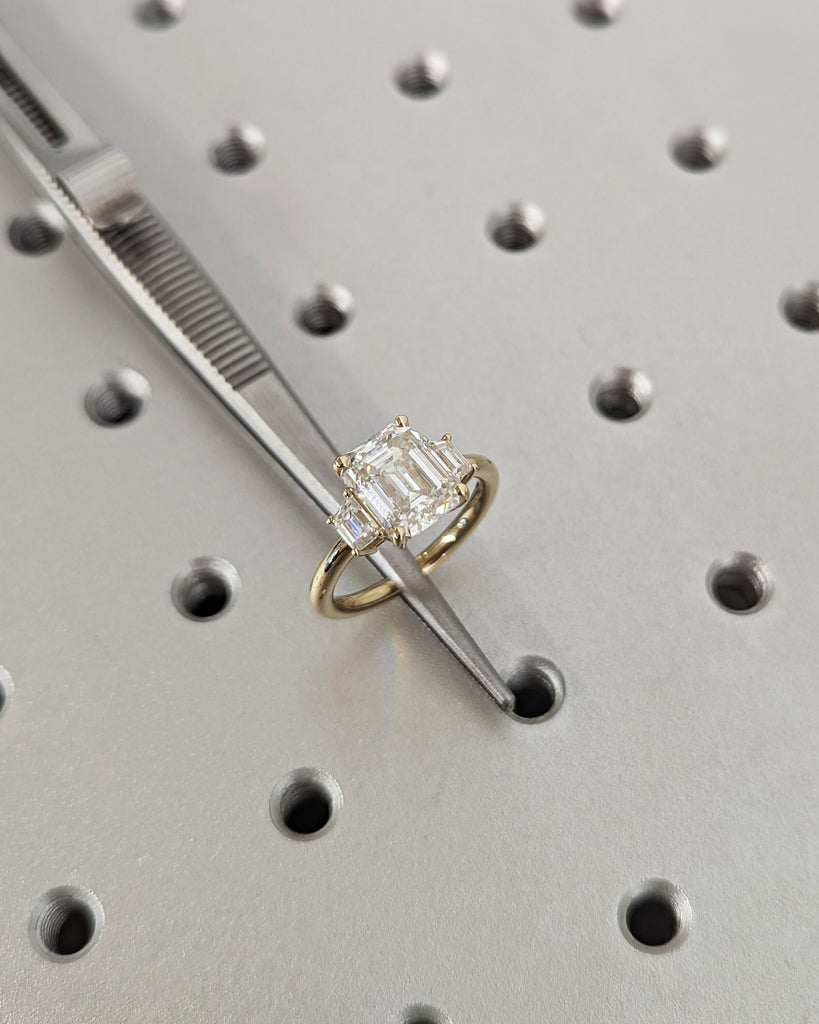 Emerald Cut Moissanite Engagement Ring. Three Stone Design with Trapezoid Accents. Unique Trellis Setting for Elegant Three Stone Ring Women